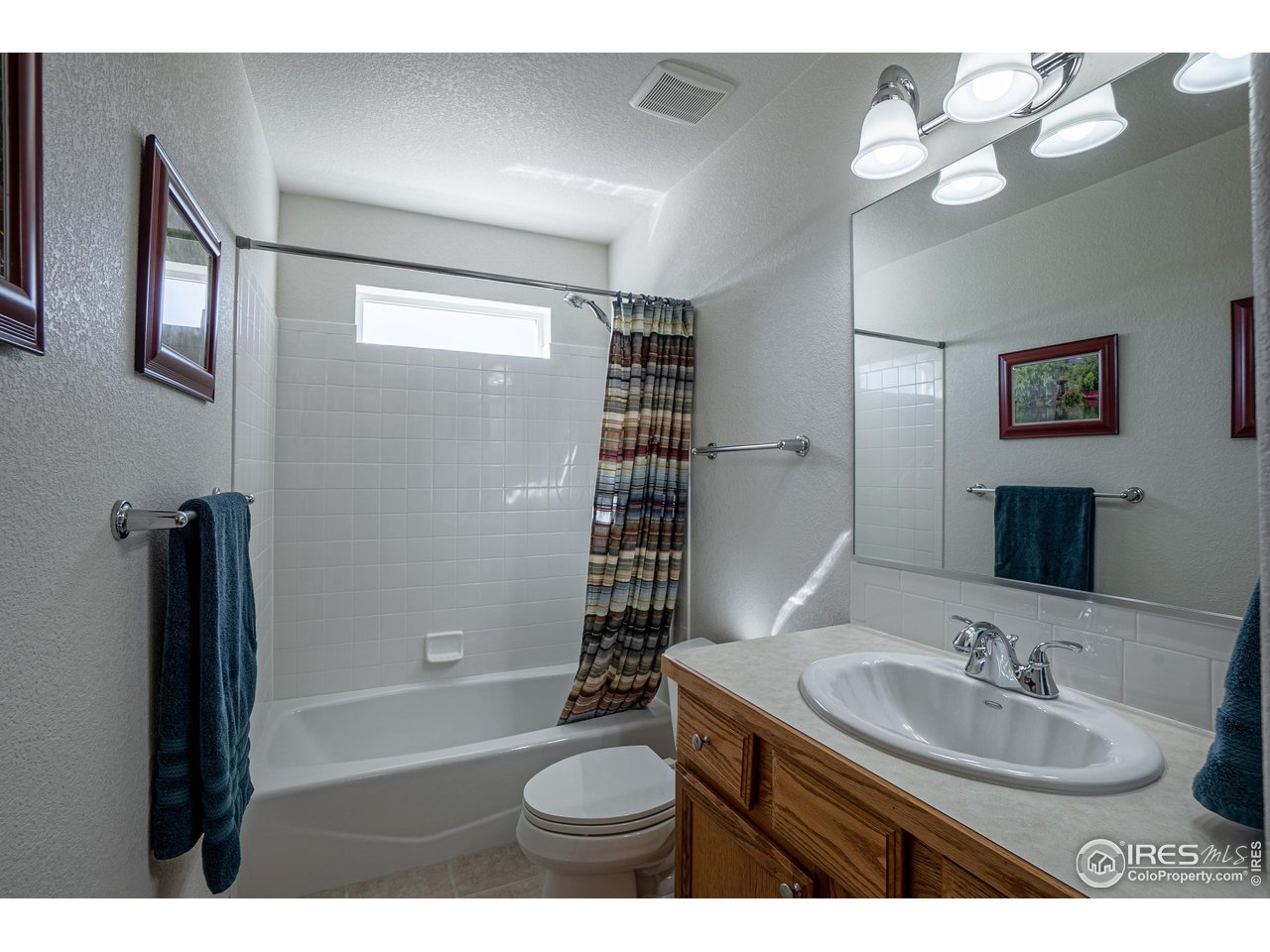 631 Linecamp Drive Livermore, CO 80536 - Photo 16 of 41 a bathroom with a sink a toilet and a mirror