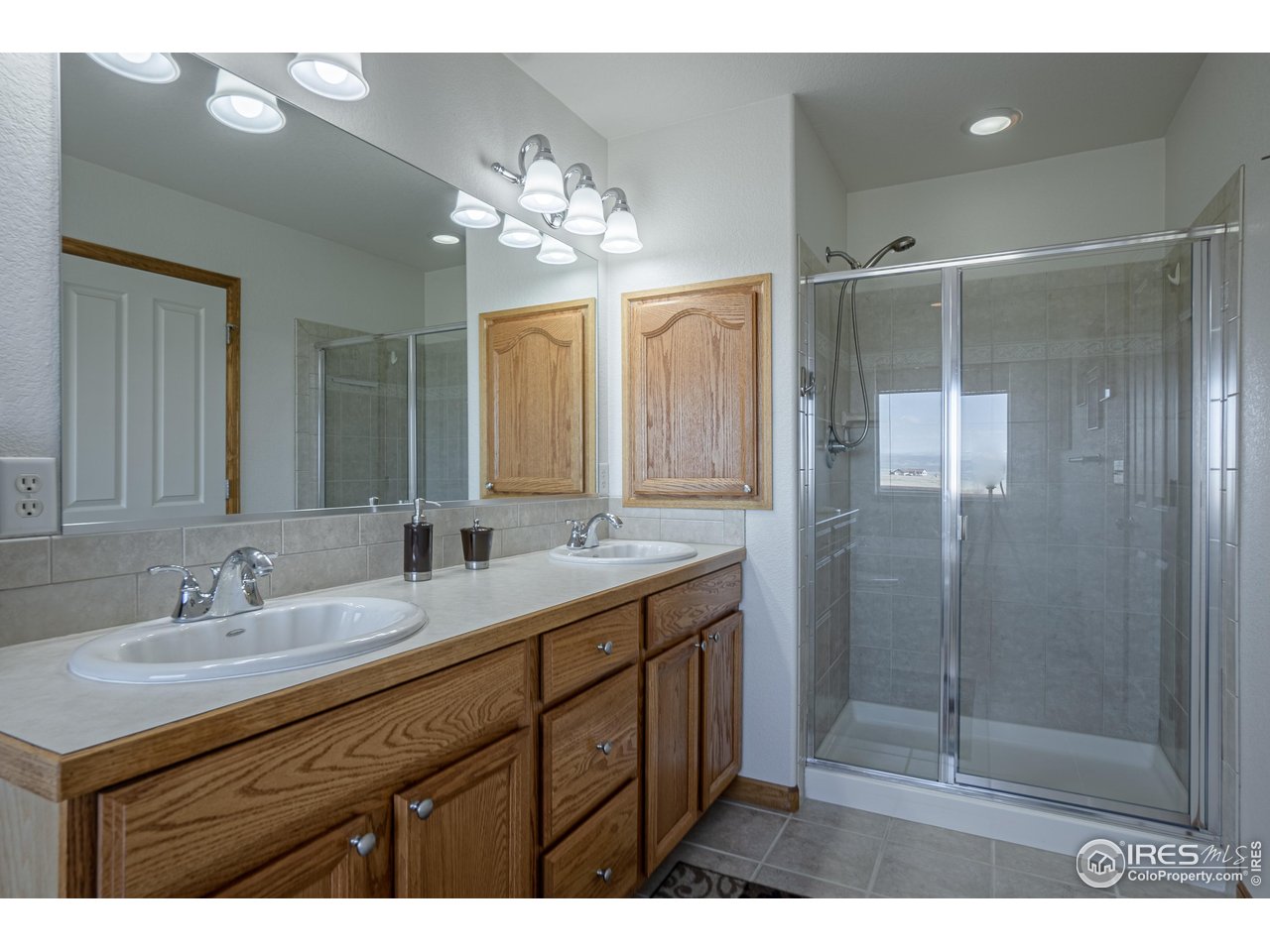 631 Linecamp Drive Livermore, CO 80536 - Photo 25 of 41 a bathroom with a double vanity sink mirror and shower