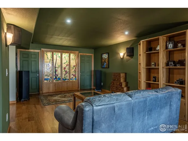 a living room with hard wood floors and a large bed