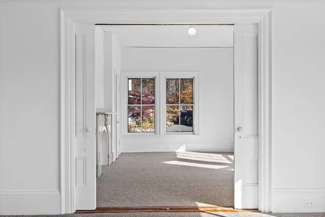 a view of an empty room with windows