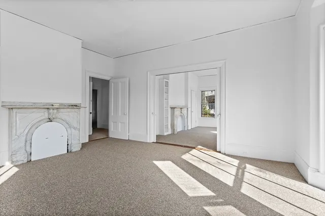 a view of a livingroom with wooden floor and a rug