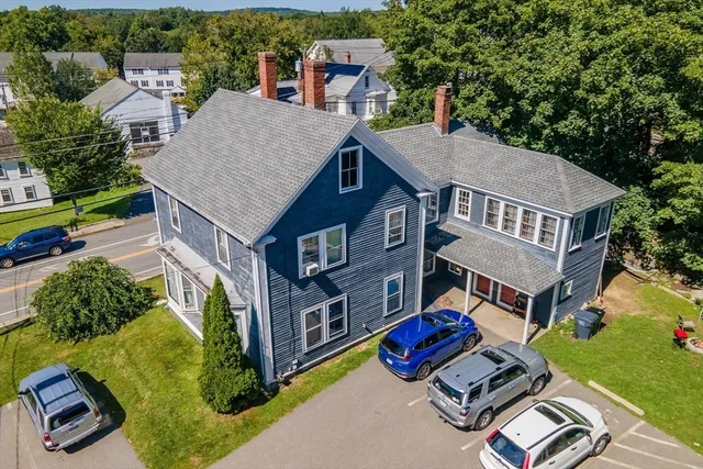an aerial view of a house with swimming pool and big yard