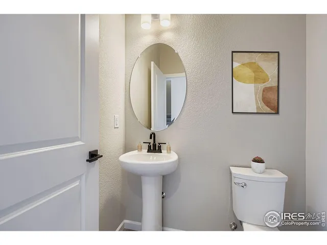 a bathroom with a sink mirror and toilet