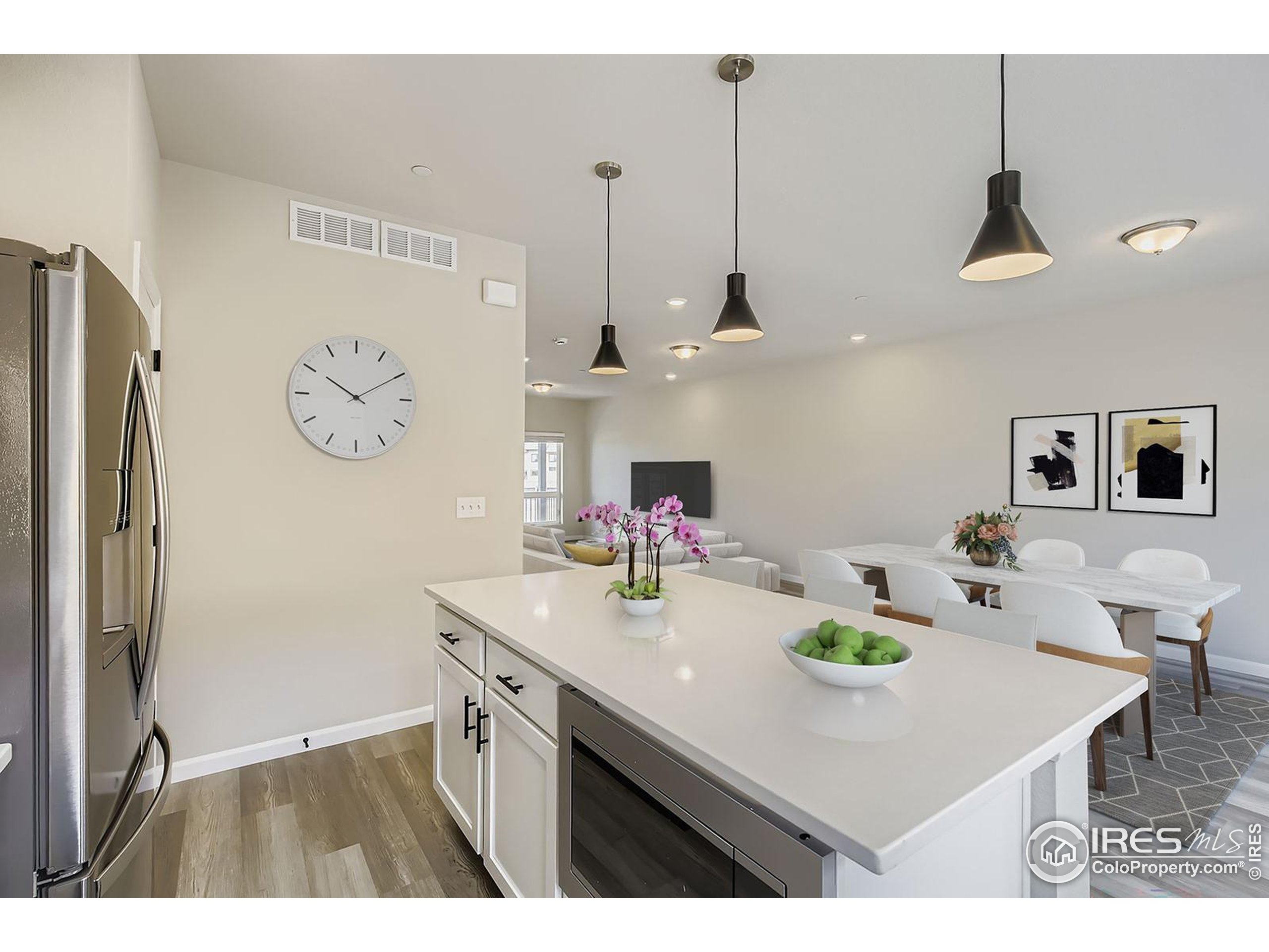 945 Abbott Lane, Unit 4 Fort Collins, CO 80524 - Photo 7 of 20 a kitchen with kitchen island a refrigerator a sink a stove and wooden floor