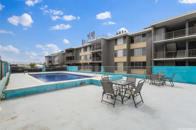 a roof deck with a table and chairs
