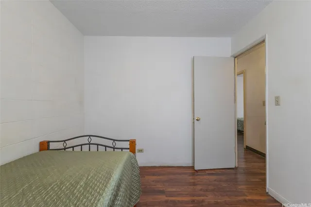 a view of a bedroom with wooden floor
