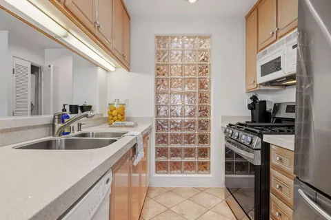 a kitchen with a sink and a stove top oven