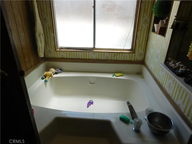 a bathroom with a tub and a window