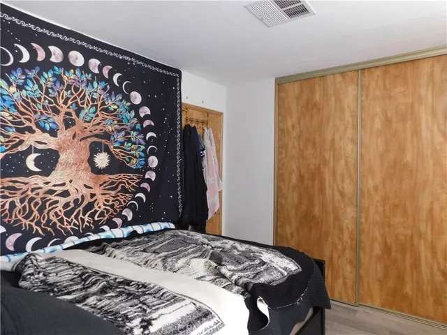 a bedroom with a bed and a curtain