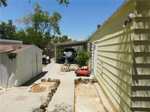 a view of a patio with table and chairs and potted plants