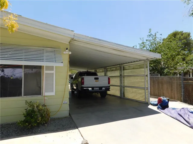 a roof deck with table and chairs and potted plants