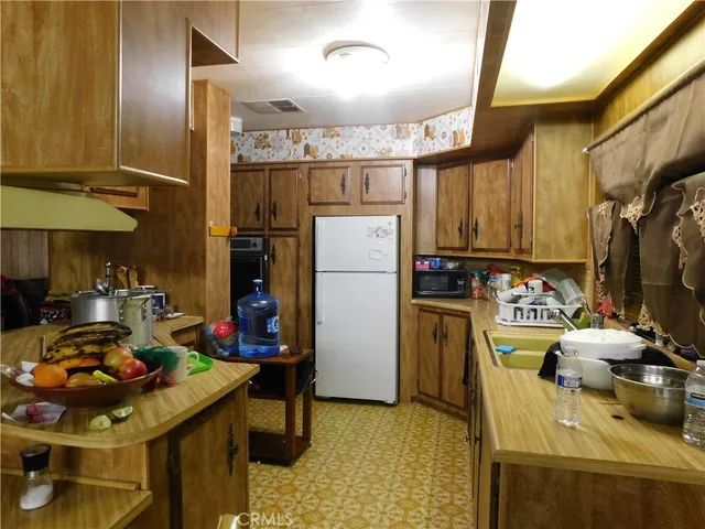 a kitchen with a refrigerator and a stove