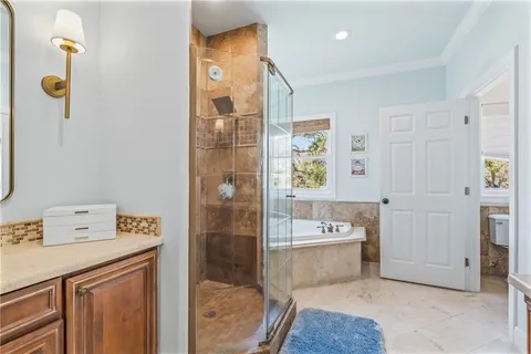 a bathroom with a tub sink and mirror