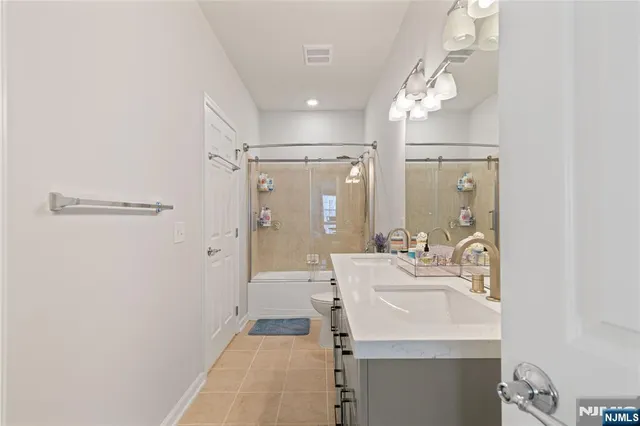 a bathroom with a sink a mirror and shower
