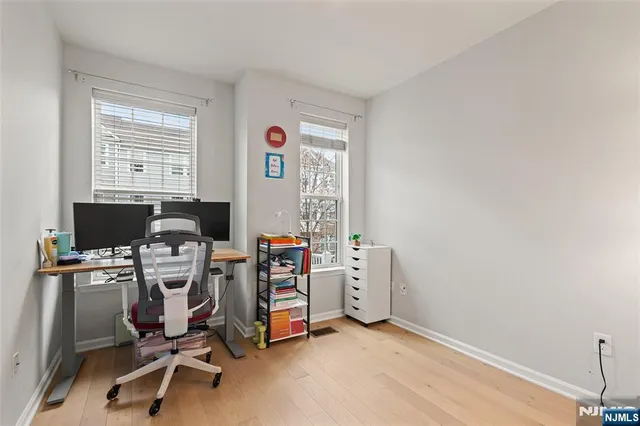 a view of a workspace with furniture and a window