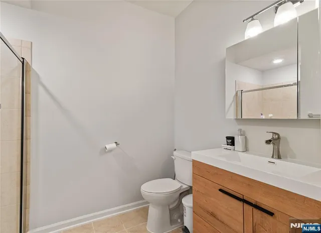 a bathroom with a sink toilet and a mirror