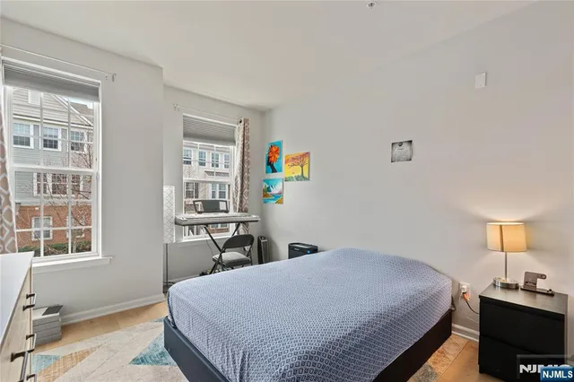 a bedroom with a bed a table and a window