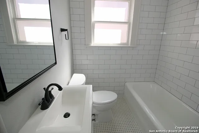a bathroom with a sink a toilet and a bathtub