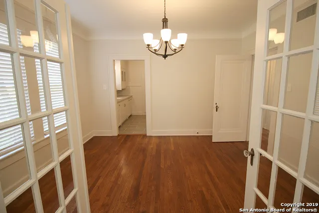 a view of a room with wooden floor and windows