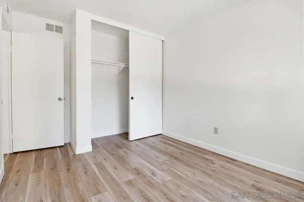 a view of room with wooden floor