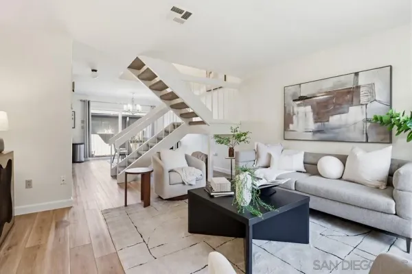 a living room with furniture and wooden floor
