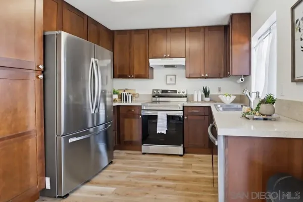a kitchen with stainless steel appliances a refrigerator sink and cabinets