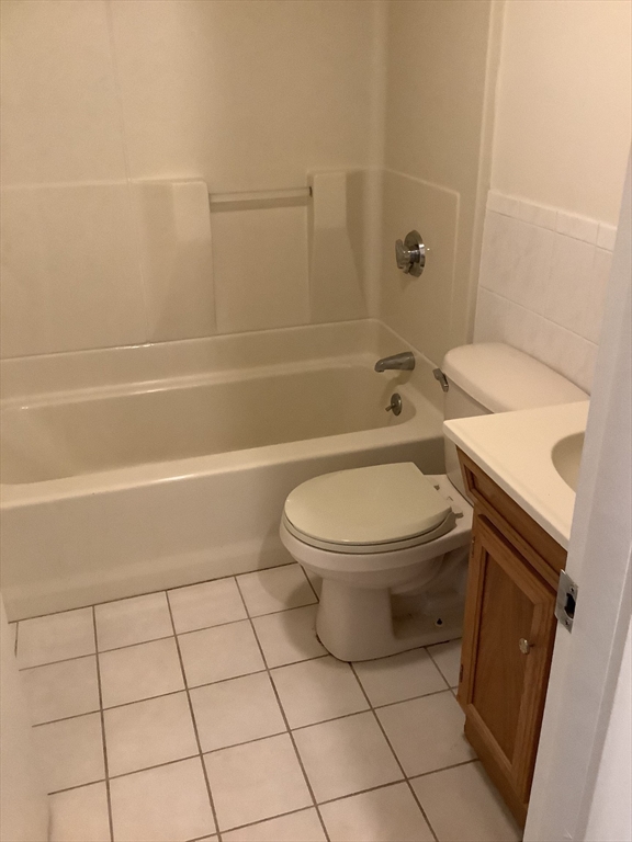 50 Cambridge Road, Unit 208 Woburn, MA 01801 - Photo 7 of 8 a white toilet and tub sitting next to a bathroom sink