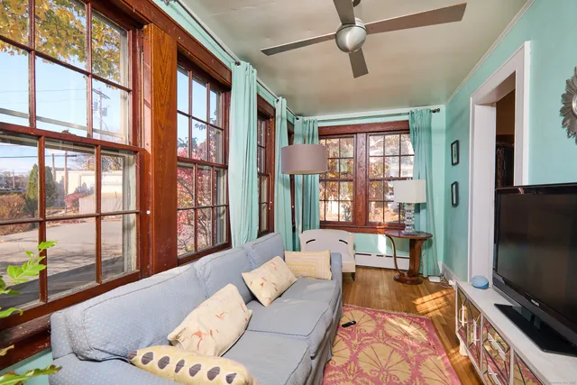 a living room with furniture tv and a window