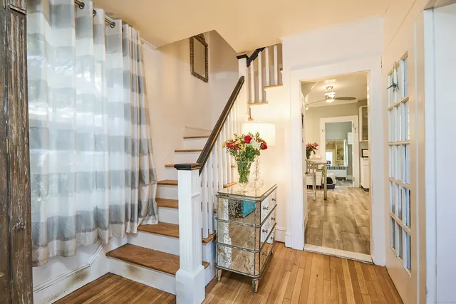 a view of entryway and hall with wooden floor