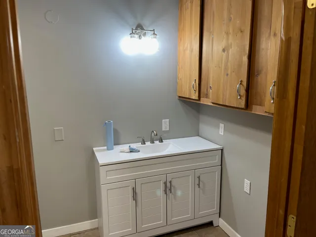 a bathroom with a sink and vanity