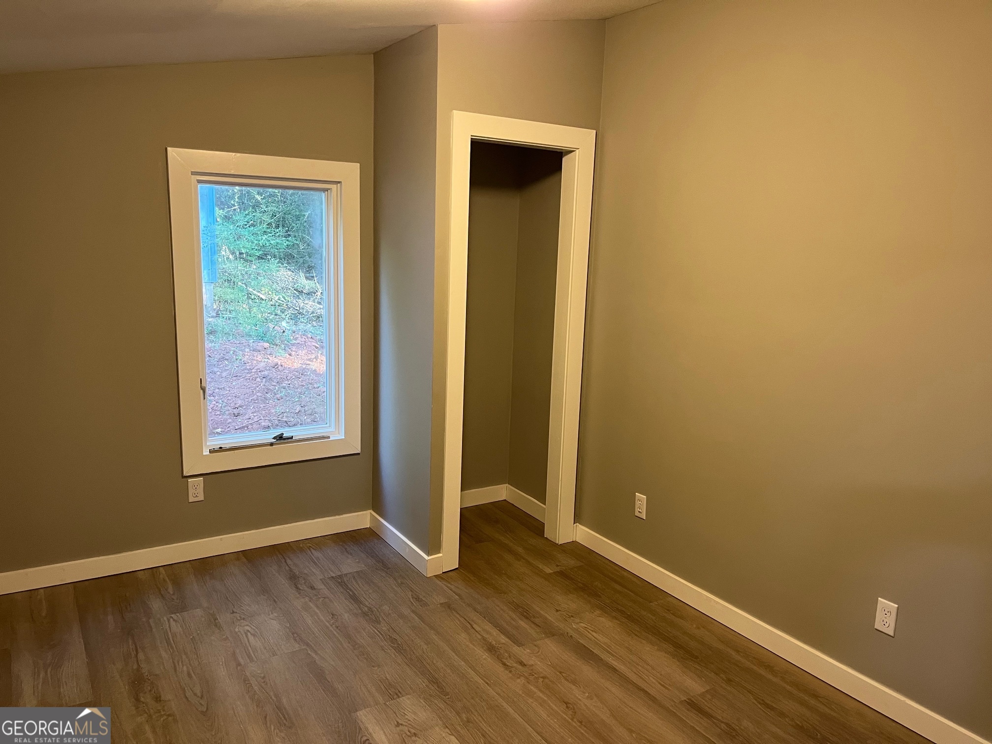 200 Cheatham Drive Athens, GA 30606 - Photo 20 of 36 a view of an empty room with wooden floor and a window
