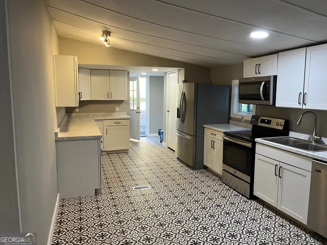 a kitchen with a sink stove and refrigerator