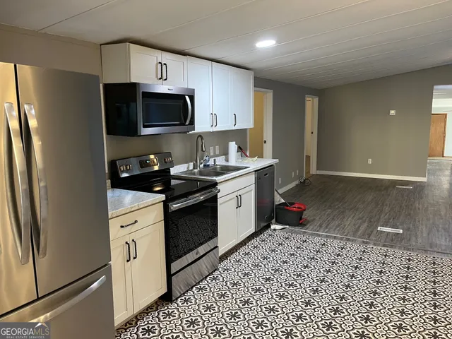 a kitchen with a sink stove and refrigerator