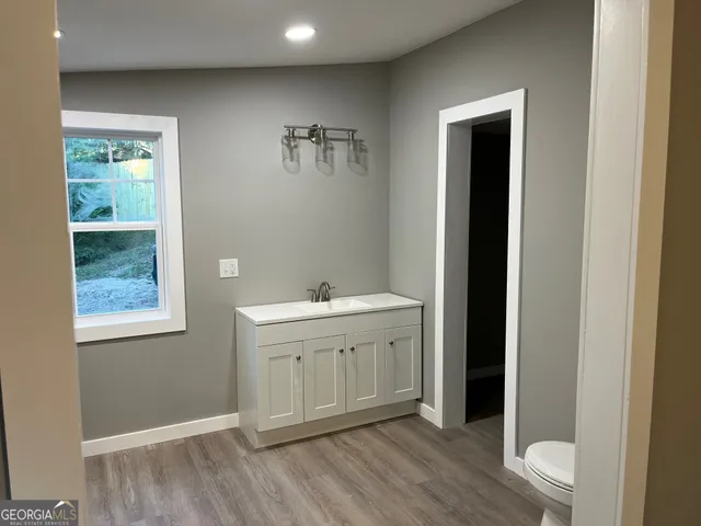a bathroom with a sink vanity and mirror