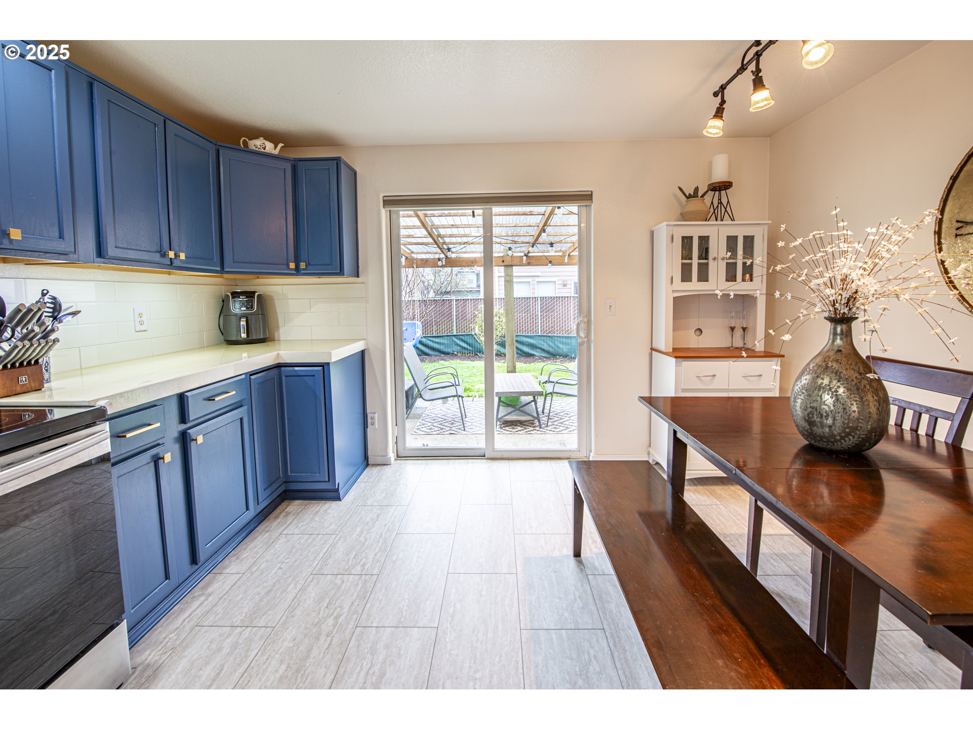 4128 Forsythia Street Springfield, OR 97478 - Photo 12 of 27 a open kitchen with kitchen island a large window a sink and stainless steel appliances