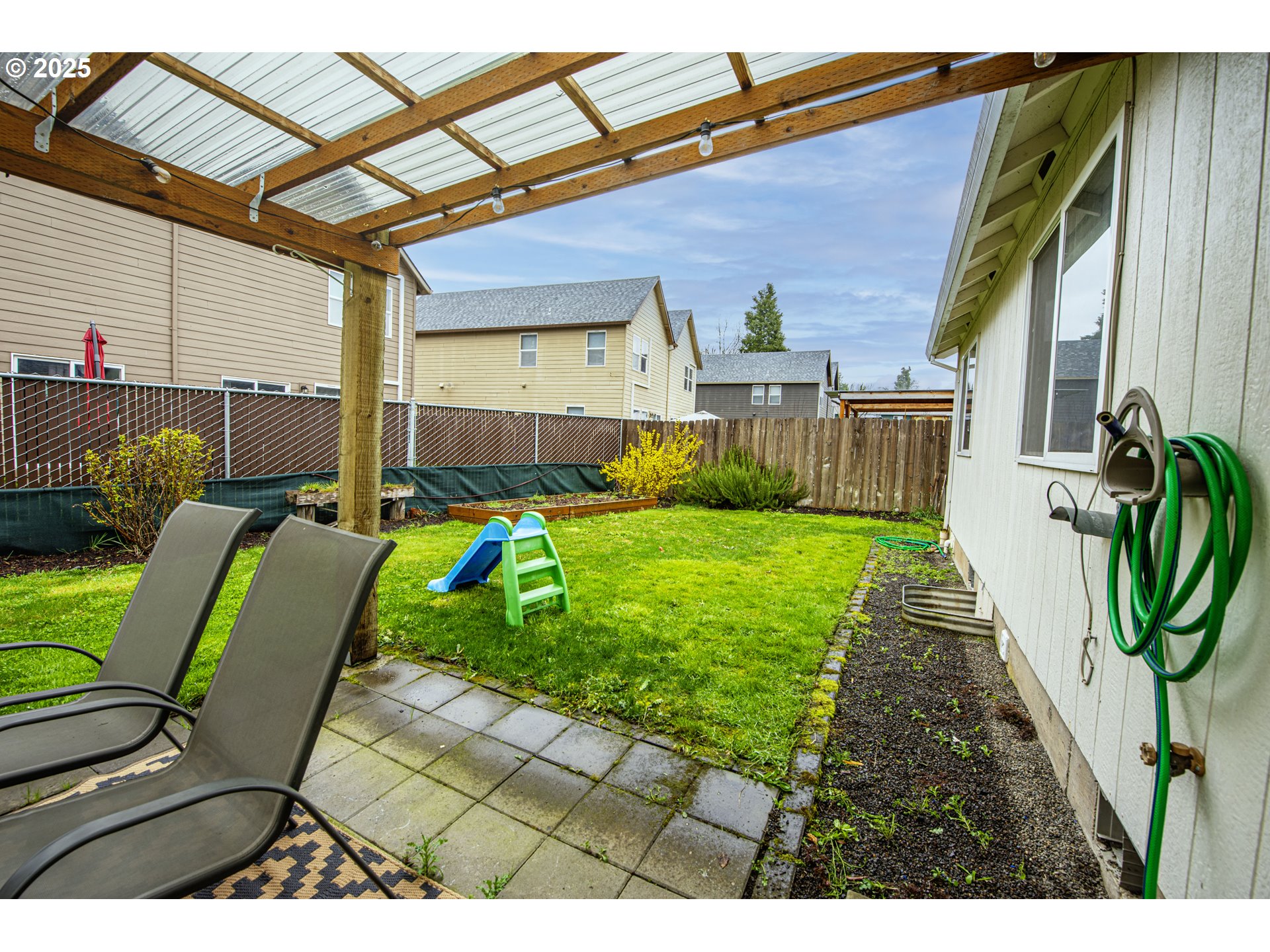 4128 Forsythia Street Springfield, OR 97478 - Photo 24 of 27 a view of a backyard with plants and a patio