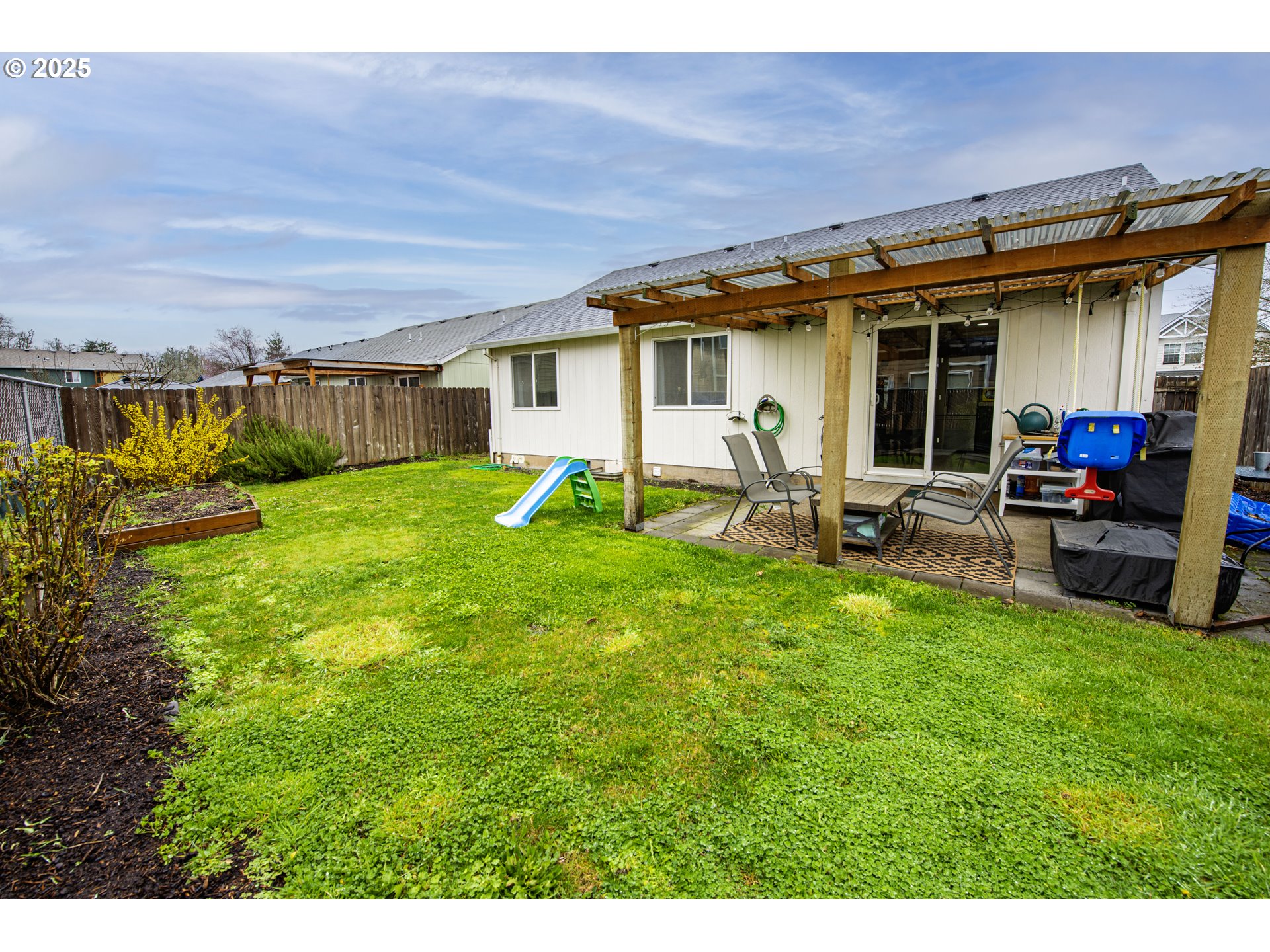 4128 Forsythia Street Springfield, OR 97478 - Photo 25 of 27 a view of a house with backyard sitting area and garden