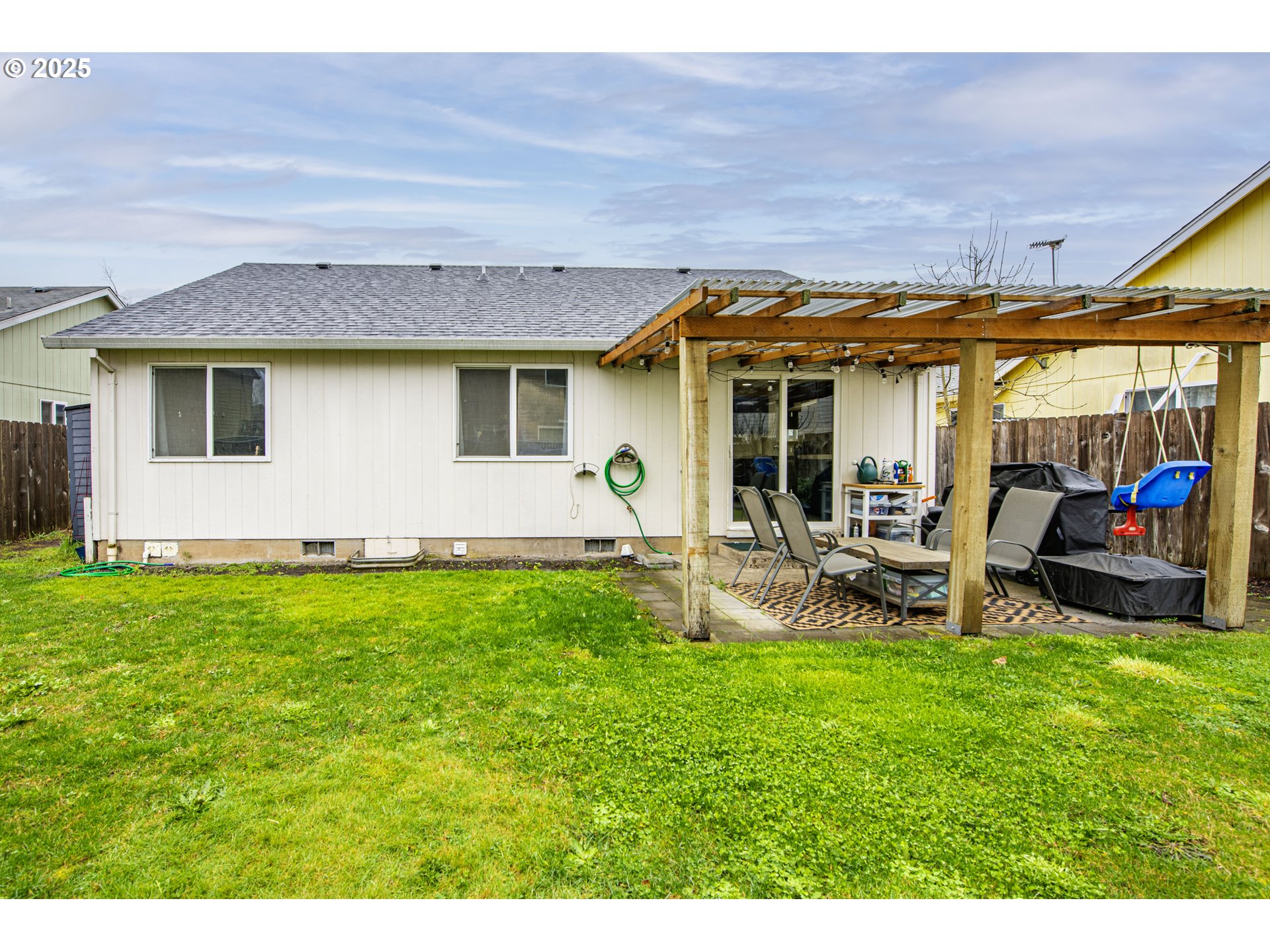 4128 Forsythia Street Springfield, OR 97478 - Photo 26 of 27 a view of a backyard with table and chairs and potted plants