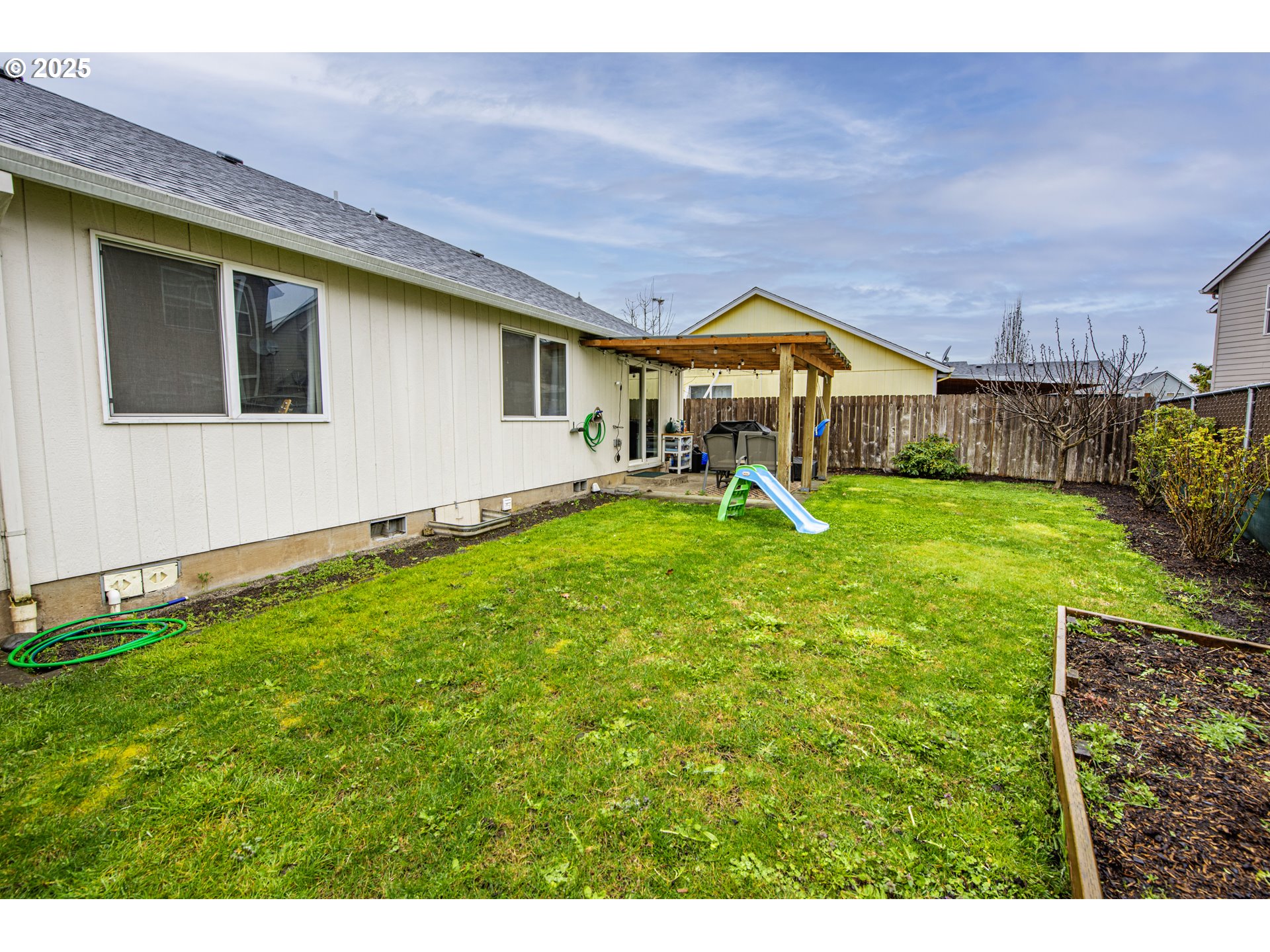 4128 Forsythia Street Springfield, OR 97478 - Photo 27 of 27 a view of a house with a yard and sitting area