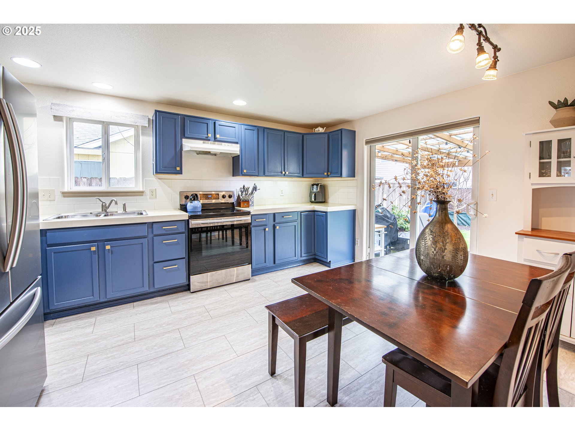 4128 Forsythia Street Springfield, OR 97478 - Photo 9 of 27 a kitchen with stainless steel appliances granite countertop a sink counter space and dining table