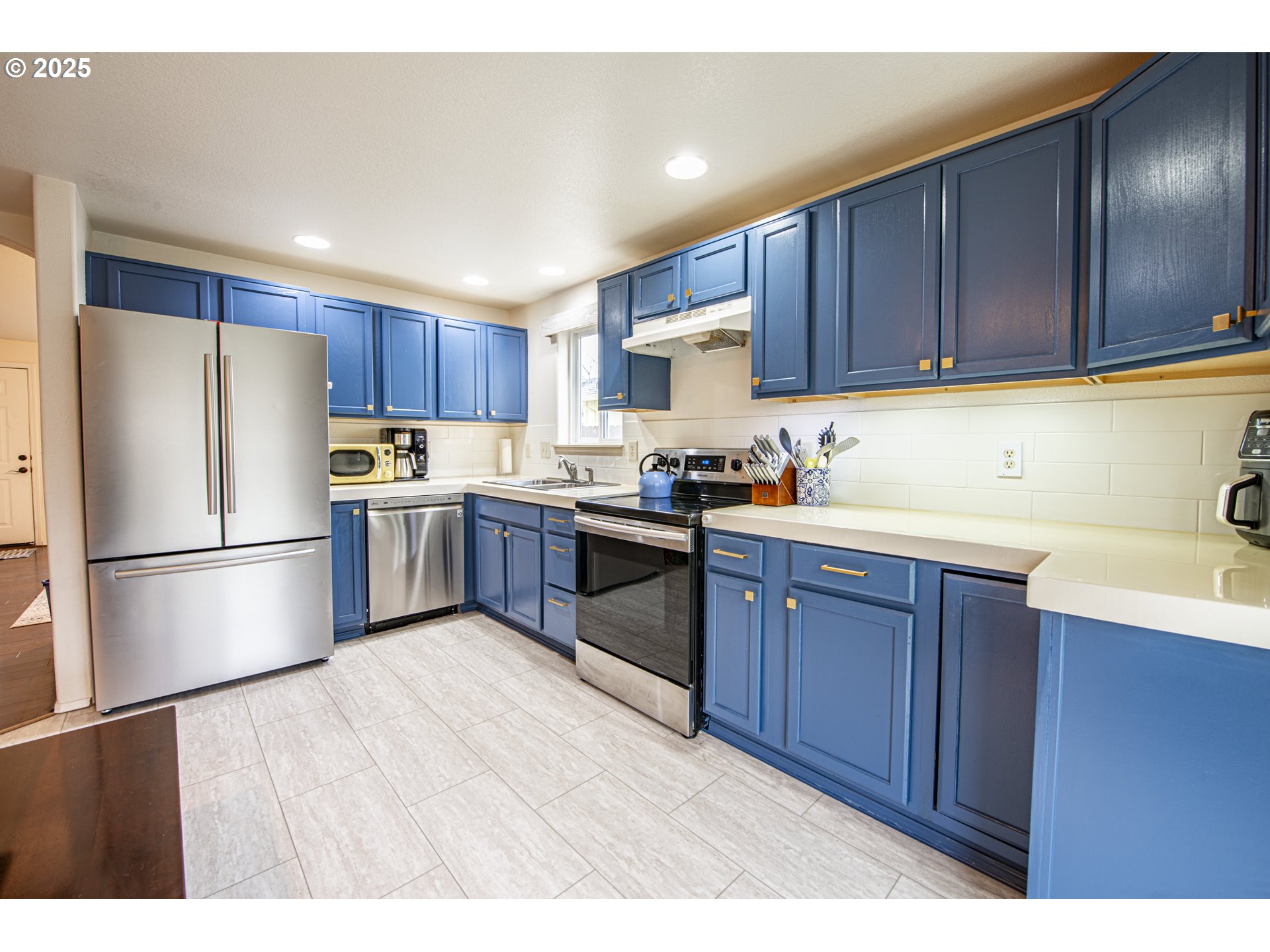 4128 Forsythia Street Springfield, OR 97478 - Photo 10 of 27 a kitchen with wooden cabinets and white stainless steel appliances
