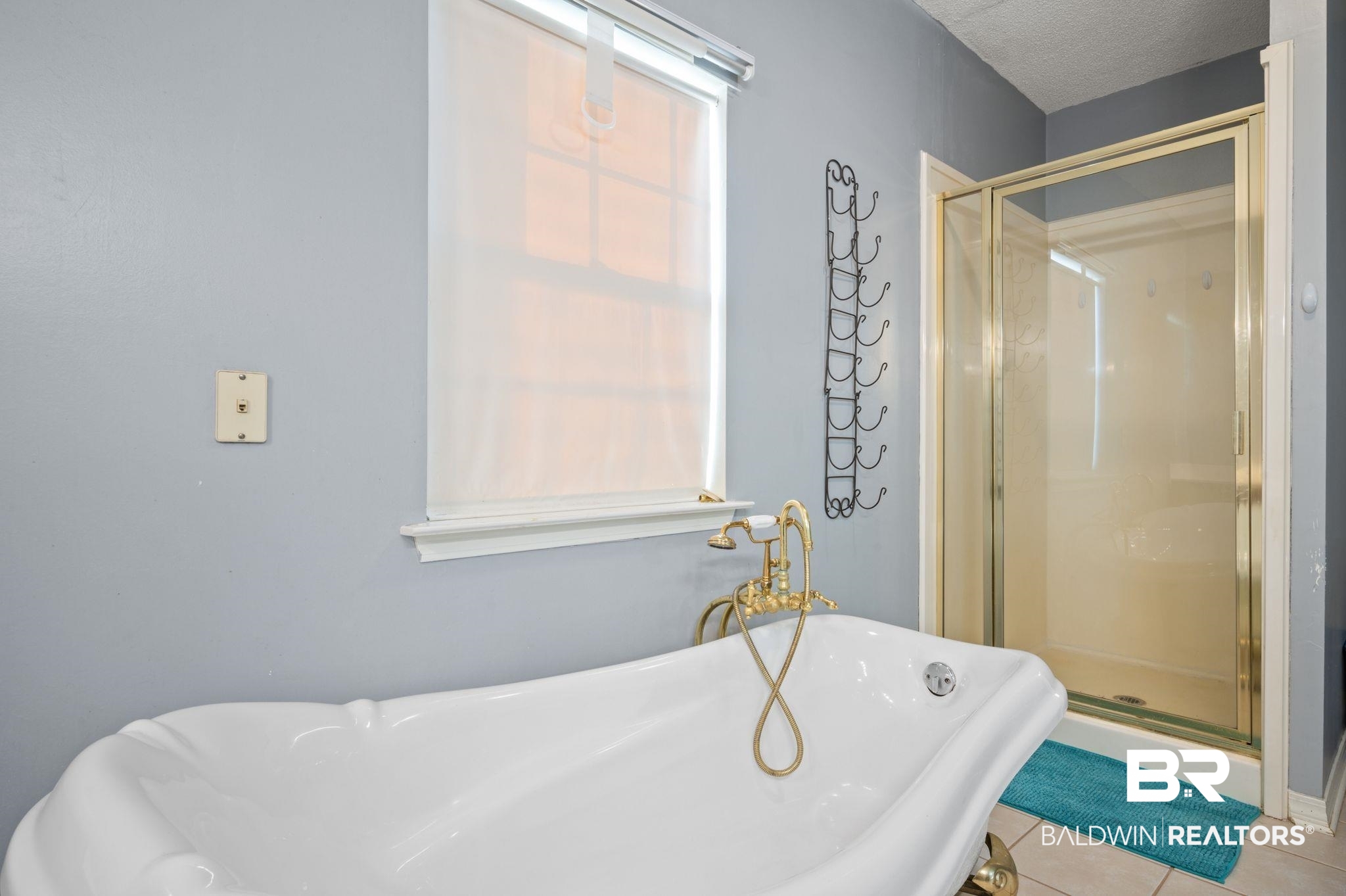 100 Orleans Way Daphne, AL 36526 - Photo 25 of 31 Bathroom featuring tile patterned flooring, a textured ceiling, and shower with separate bathtub