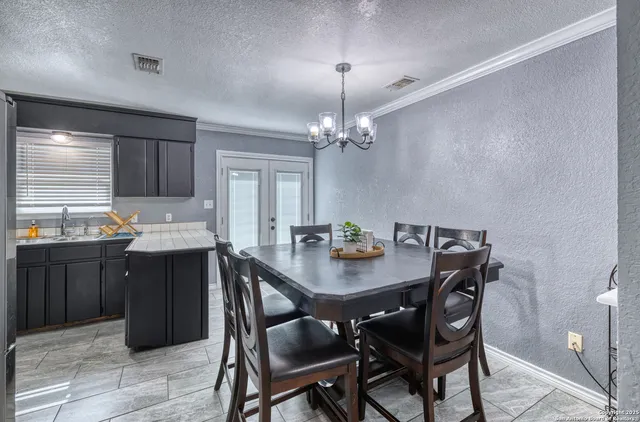 a kitchen with a table and chairs in it