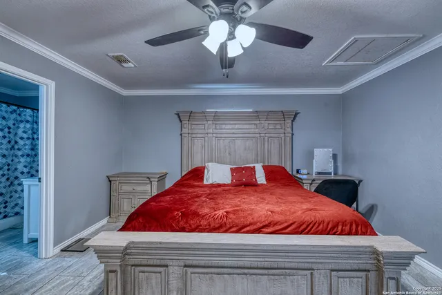 a bedroom with a bed and a chandelier