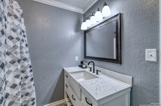 a bathroom with a sink and a mirror