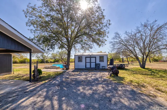 a view of a house with a yard covered in snow