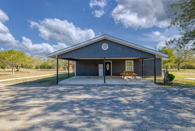 a view of a house with a yard and tree s