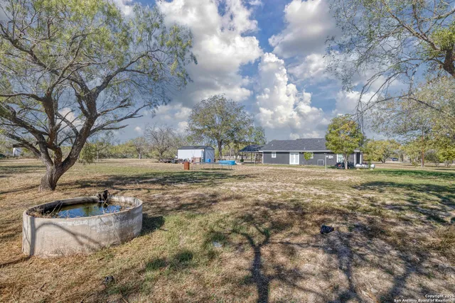 a view of outdoor space with deck and trees