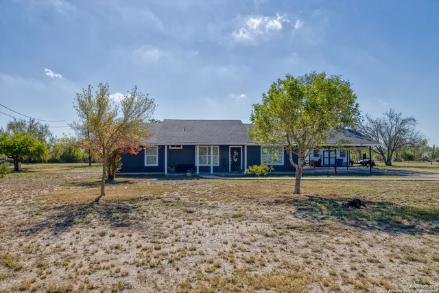 a house that has a tree in front of it