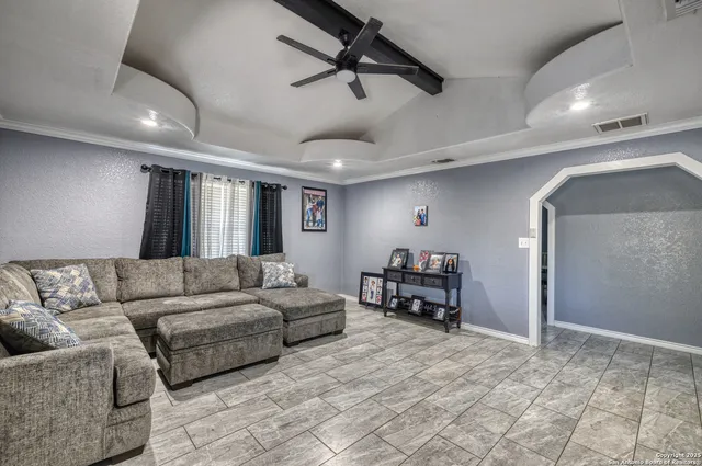 a living room with furniture and a dining table with projector